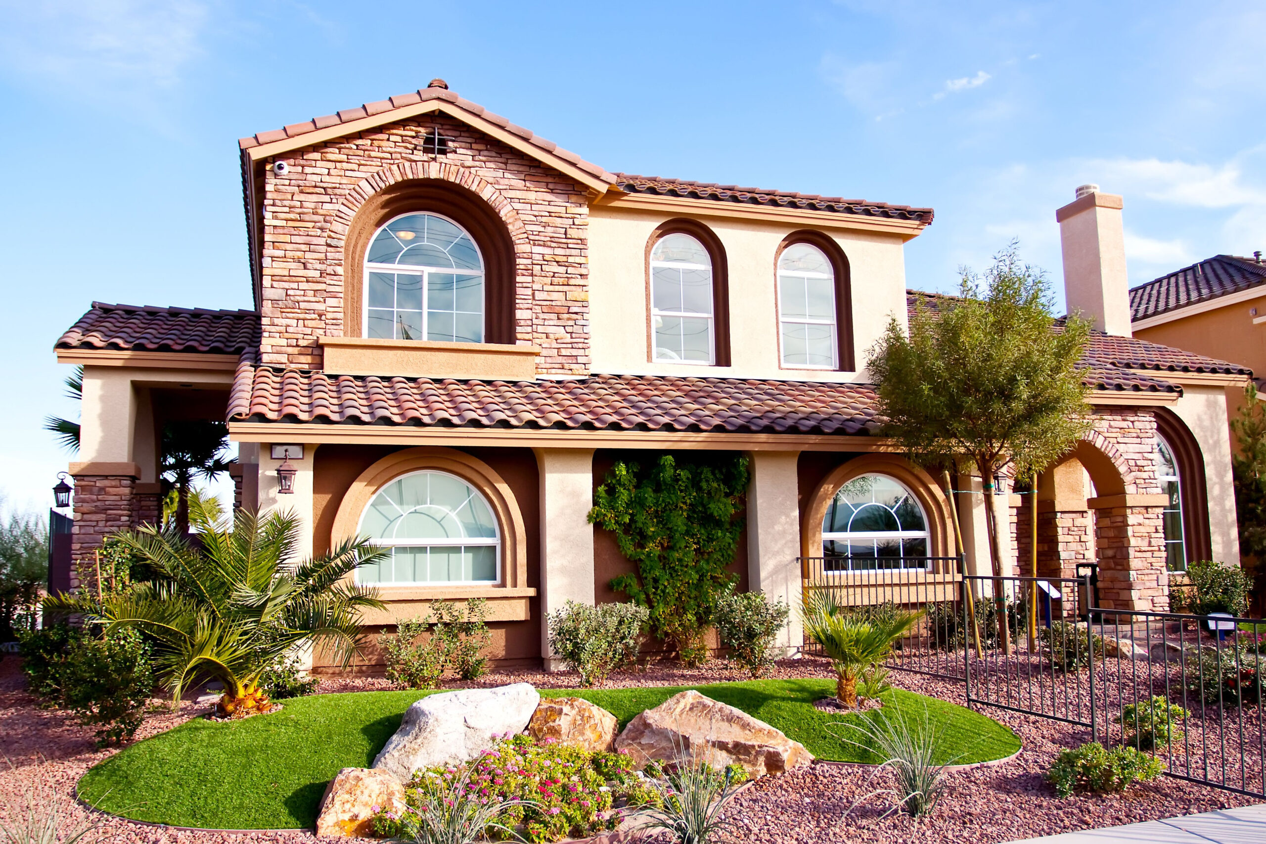 Exterior view of a stucco house white condo buildings