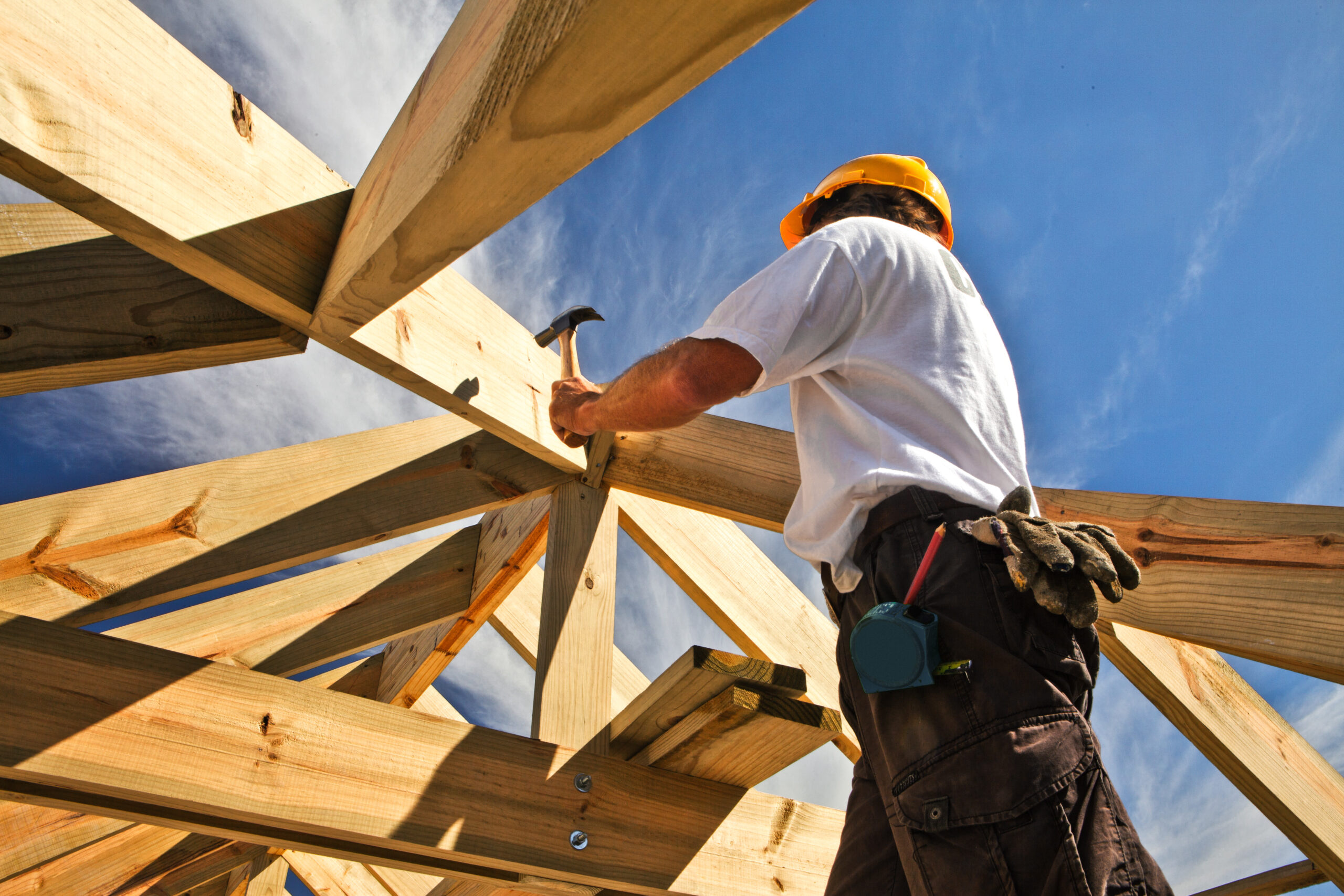 roofer ,carpenter working on roof structure at construction site carpenter working in a roof