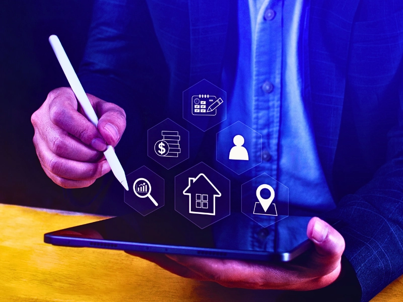 Understanding the Role of Technology in Home Appraisals_144521971_Altered_Tyke Person using stylus on tablet with real estate interface icons.