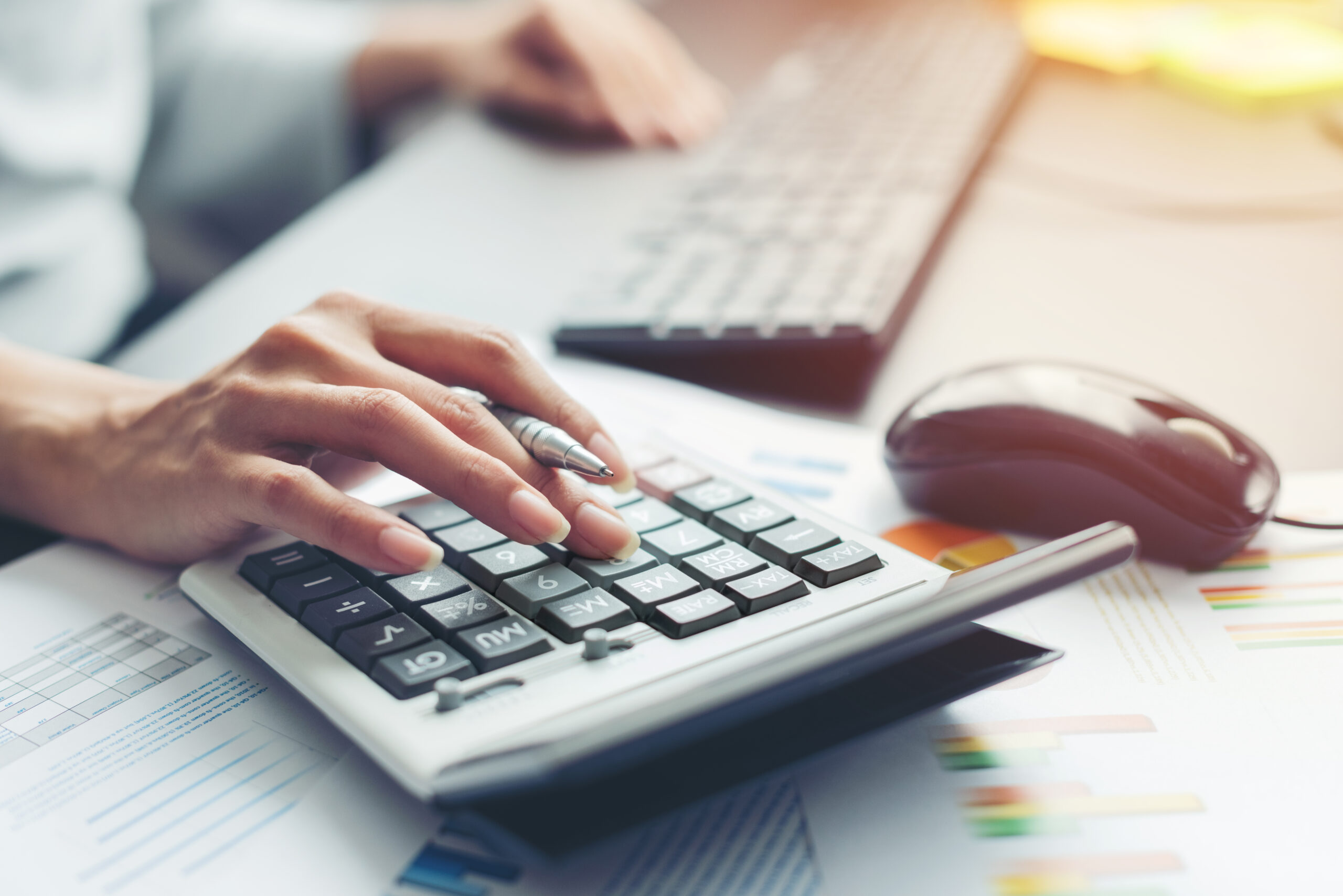hand of business woman accountant or banker making calculations. a hand and a calculator